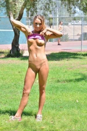 Fit blonde jogger in short shorts revealing wide open twat in public park on fanspics.com