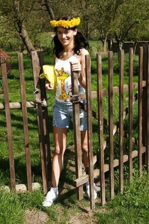 Sweet brunette teen Amanda undressing her clothes outdoors on fanspics.com