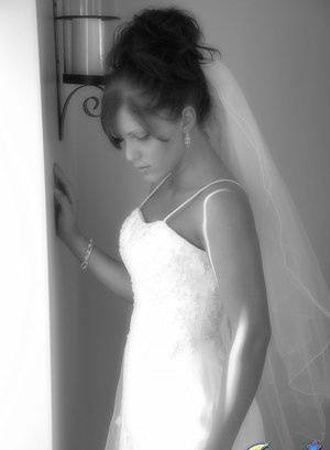 Young amateur wears her hair done up while modelling bridal wear on fanspics.com