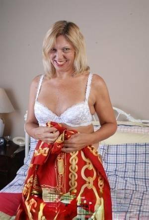 Older blonde lady removes hot white lingerie set for cunt masturbation on fanspics.com