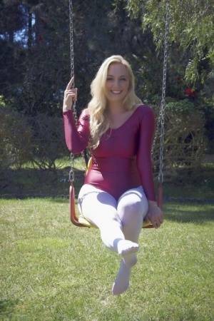 Busty blonde Hayley Marie Coppin strips bodysuit and white pantyhose outdoors on fanspics.com