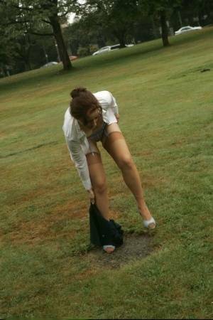 Amateur chick Dirty Angie strips to her pretties and tan nylons in a park on fanspics.com