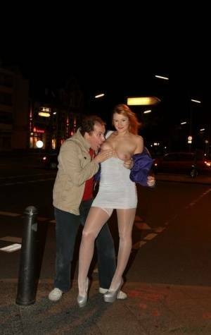 Slutty LaMia in white stockings topless sucks on her knees in the street on fanspics.com