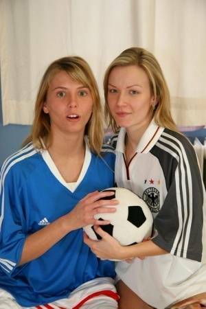 Cute teen girls go lesbian after trying on soccer outfits on a bed on fanspics.com