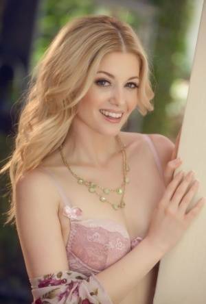 Beautiful blonde Charlotte Stokely uncovers tiny tits before petting her pussy on fanspics.com