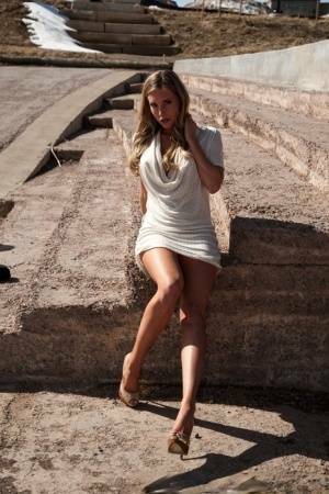 Hot blonde in white dress flashes pierced tits & naked pussy upskirt outdoors on fanspics.com