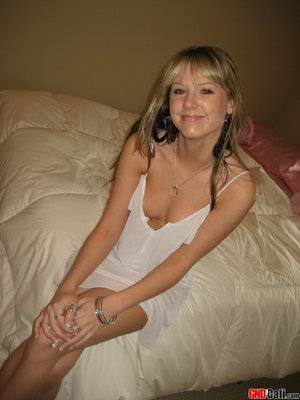 Cute teen Cali strips out of her little white nighty on fanspics.com