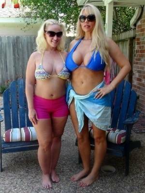 Blonde chicks Karen Fisher and Dee Siren loose their big tits from bikini tops on fanspics.com