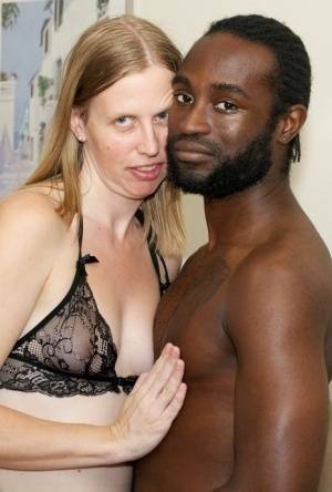 White amateur deepthroats her black lover's cock in lingerie ensemble on fanspics.com