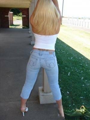 Blonde amateur Karen exposes her lace thong while outdoors in faded jeans on fanspics.com