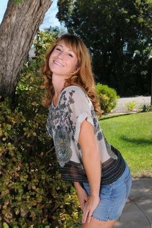 Redhead MILF Sophia K removes jean shorts as she disrobes under patio tree on fanspics.com