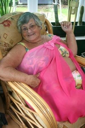 Horny old granny in glasses disrobes to reveal huge saggy tits & big BBW ass on fanspics.com