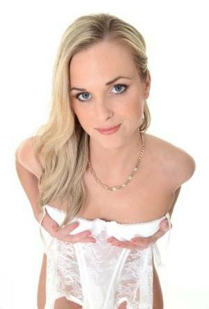 Pretty blonde Vinna Reed takes off white lingerie and matching hosiery on fanspics.com