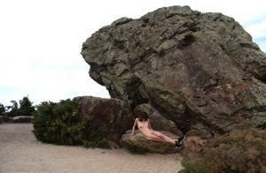 Amateur chick poses totally nude in running shoes near huge boulders on fanspics.com