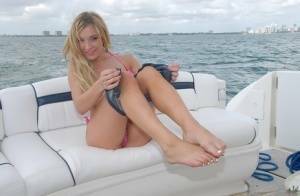 Lusty blonde Amy Brooke strips bikini and rubs pussy on the boat on fanspics.com