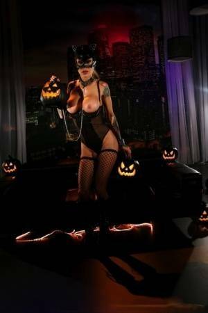 Tattooed chick Sarah Jessie exposes her tits and twat in a Catwoman mask on fanspics.com