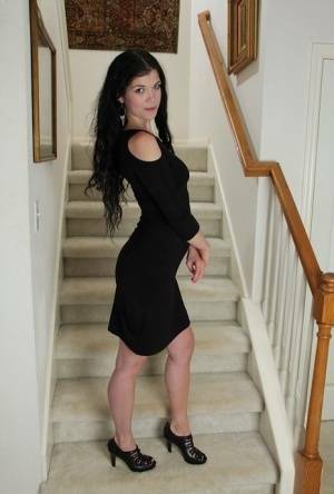 Clothed milf beauty Veronica Stewart is taking off her black dress on fanspics.com