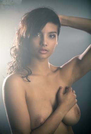 Beautiful Desi female removes her dress to expose her big natural boobs on fanspics.com