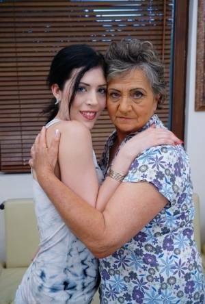 Lesbian granny worshipping sexy teen's attractive body and holes on fanspics.com