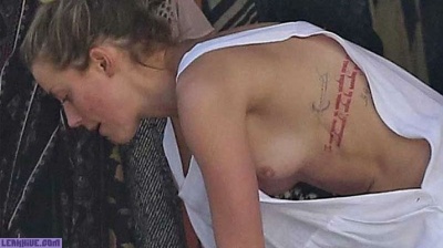 Amber Heard caught topless on the beach on fanspics.com