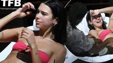 Dua Lipa Wears a Hot Pink Bikini as She Relaxes by the Pool with a Mystery Man in Miami on fanspics.com