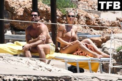 Michelle Hunziker & Giovanni Angiolini Relax on the Beach of Their Hotel in Sardinia on fanspics.com