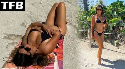 Claudia Romani Shows Off Her Curves on the Beach on fanspics.com