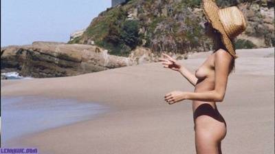 Camille Rowe nude on the beach on fanspics.com
