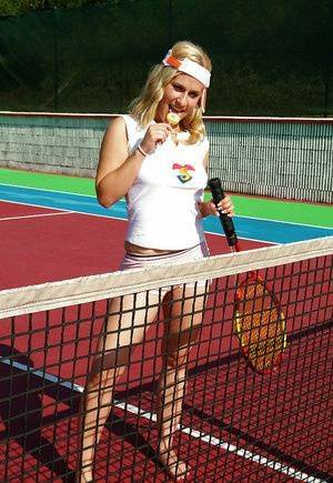 Sporty babe with big tits Angel B toying her cunt on the tennis court on fanspics.com