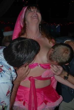 Mature lady Dee Delmar and friends hit the swing club for Christmas orgy on fanspics.com