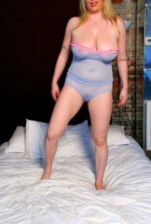 Blond amateur Maggie Green sports a cameltoe while unleashing her big naturals on fanspics.com