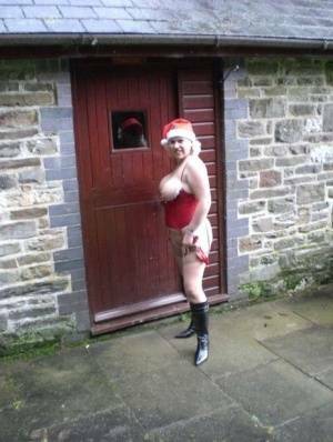 Blonde amateur Barby releases her big tits and butt from Xmas lingerie outside on fanspics.com