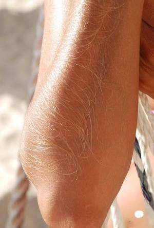 Amateur model Lori Anderson shows her hairy arms in a bikini and sunglasses on fanspics.com