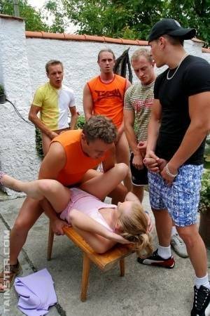 Clothed Euro slut takes on five men during a gangbang on patio on fanspics.com