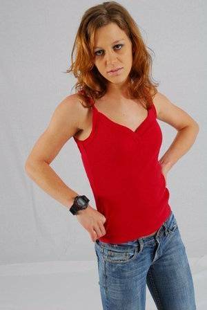 Natural redhead Sabine shows off her black G-shock watch while fully clothed on fanspics.com