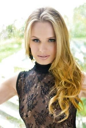 Blonde babe model Jillian Janson strutting outdoors in black bodystocking on fanspics.com