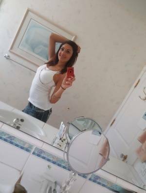 Nasty brunette slut Nikka taking couple of selfies in the bathroom on fanspics.com