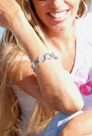 Amateur model Lori Anderson shows off her hairy arms while fully clothed on fanspics.com