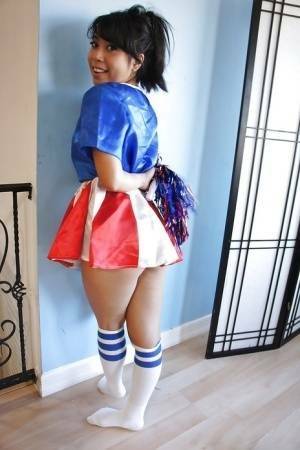 Tiny Asian cheerleader May Lee posing in cute uniform and socks on fanspics.com