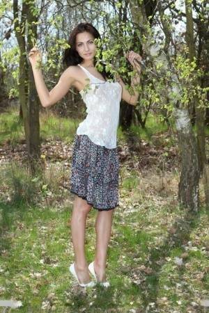 Long legged Michaela Isizzu flashes naked upskirt and poses nude in the forest on fanspics.com