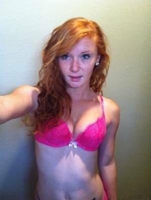 Natural redhead Alex Tanner slips off her pink lingerie set for nude selfies on fanspics.com