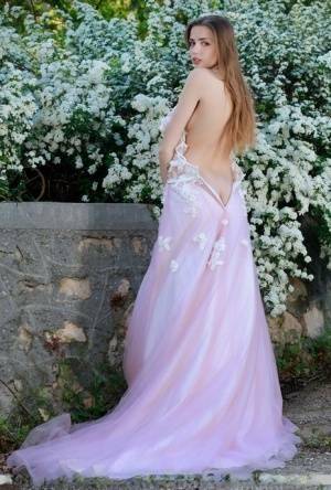 Beautiful girl Elle Tan slips off wedding dress to pose nude in garden on fanspics.com