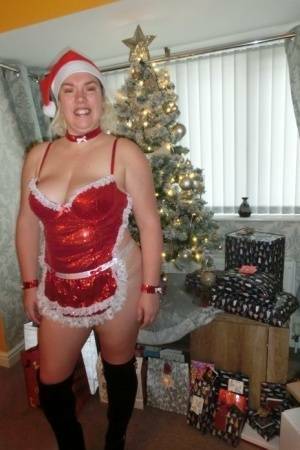 Busty blonde Barby masturbates her shaved pussy near the Christmas tree on fanspics.com