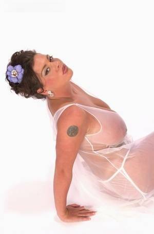 Buxom Linsey Dawn poses to flaunt her droopy tatas in sheer lingerie on fanspics.com