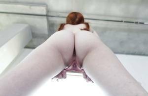 Young redhead Dolly Little revealing shaved pussy in pigtails and socks on fanspics.com