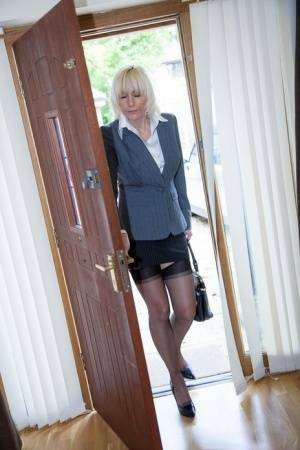 Older MILF Jan Burton strips off business clothes after a hard day at office on fanspics.com