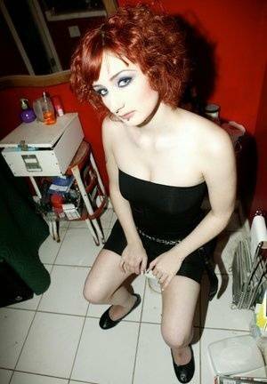 Pale redhead Violet Monroe gets naked in flat shoes while in a bathroom on fanspics.com