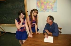 2 cheerleaders jerk off their geography teacher on top of his desk on fanspics.com