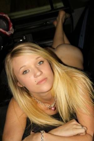 Blonde amateur Teagan slides lace panties aside to get naked inside a vehicle on fanspics.com