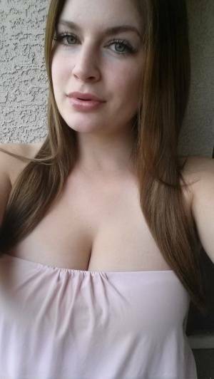 Plump amateur Danielle takes topless and clothed selfies around the house on fanspics.com